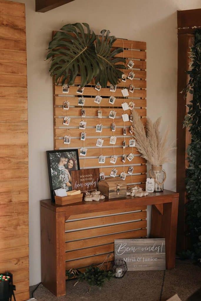 Enchanting Rustic Bridal Shower Ideas for a Memorable Celebration. 9 Wooden panel with hanging photographs