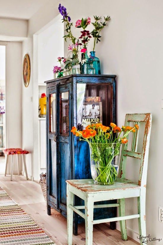Timeless Charm: Vintage Movies Transforming Your Decor Aesthetics. 3 Blue dresser and white chair