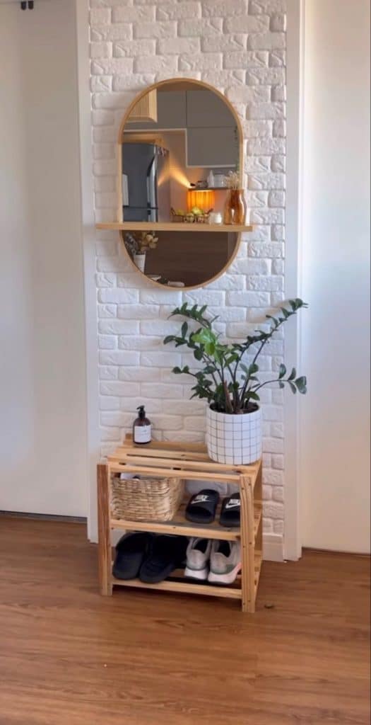 Transform Your Small Walls with Stunning Decor Ideas. 3 White wall with bricks, a shoe rack, and an oval mirror