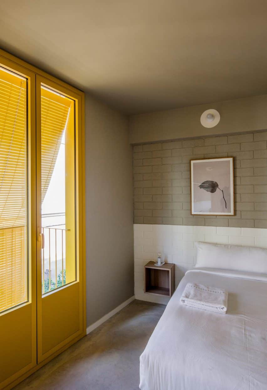 Seven Lives by Anna and Eugeni Bach features yellow accents on the facade, adding vibrancy to the apartment interiors.