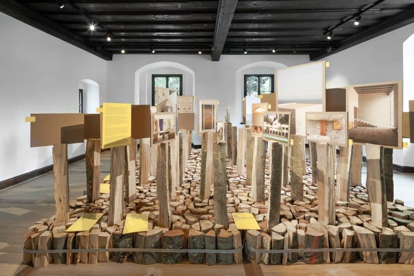 Medprostor Stacks Firewood for Ljubljana Design Biennial 4 Images held up by vertical logs.