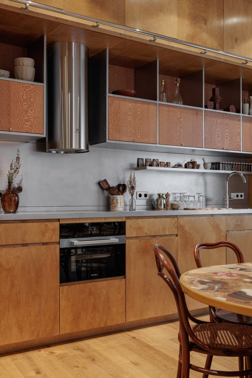 Image of Casa Franca, a home in Paris characterized by a large rammed-earth wall and interiors featuring travertine stone and birch wood.