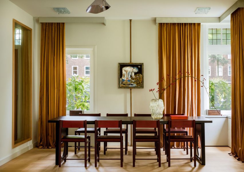 DAB Studio Revives 1920s Dutch Home with Contemporary Design 3 Mustard-coloured curtains in the dining space add warmth to the interior.