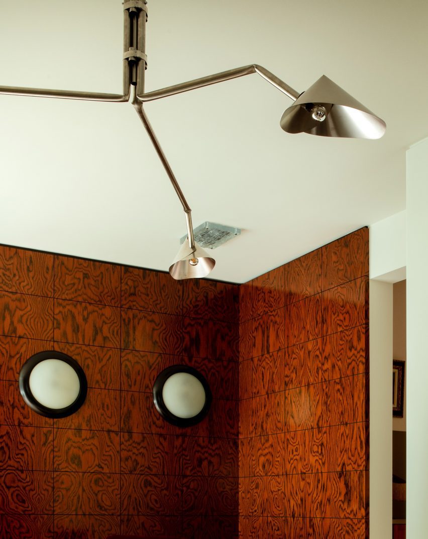DAB Studio Revives 1920s Dutch Home with Contemporary Design 4 A gridded feature wall in the living area captures the artistic influence of the Amsterdam School.