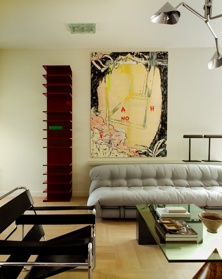 DAB Studio Revives 1920s Dutch Home with Contemporary Design 2 The living room in Collectors Home by DAB Studio shows an elegant design with a neutral-hued fireplace and modern details.