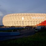 Allianz Arena on a night view showcasing its illuminated cladding.
