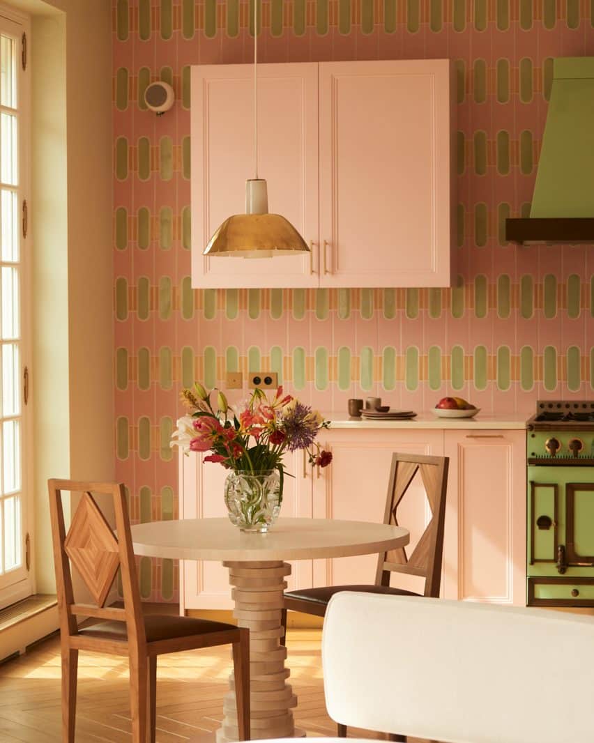 The kitchen features a colorful mix of traditional and contemporary design elements.