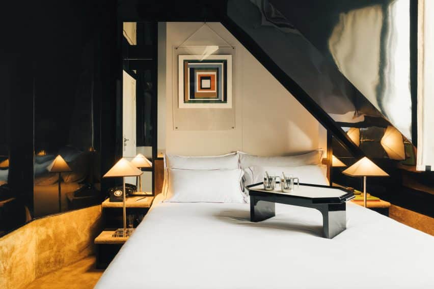 Necchi Architecture Evokes Retro Nightlife in Hotel Château d'Eau, Paris 2 The lobby area showcasing collectible furniture and a curved reception desk adorned with chrome panelling.