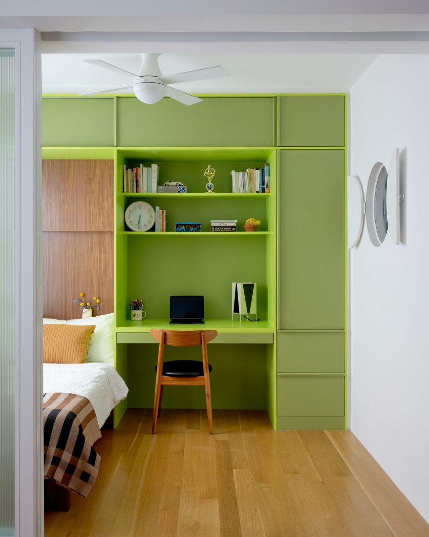 The renovated bedroom highlights a lime green built-in with a bed, desk, and storage.