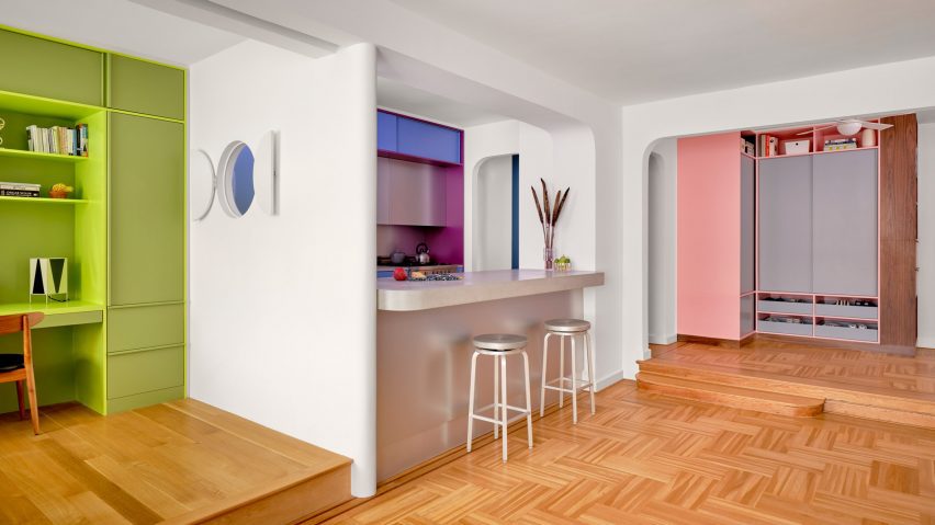A side view of the apartment showcasing the colorful living area and kitchen.