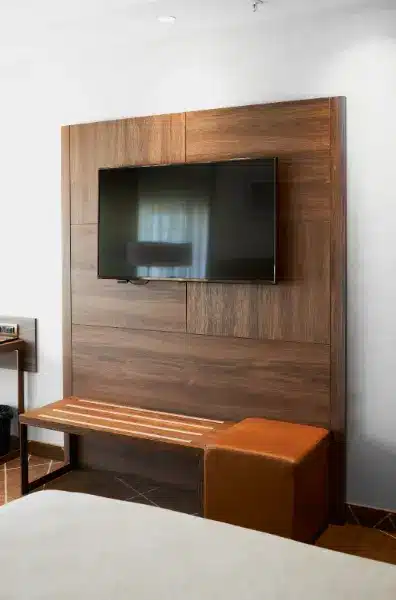 Transform Your Living Room with Stunning TV Panel Ideas. 5 Include a bench below the TV panel to gain extra space for putting on shoes – Photo: Shutterstock