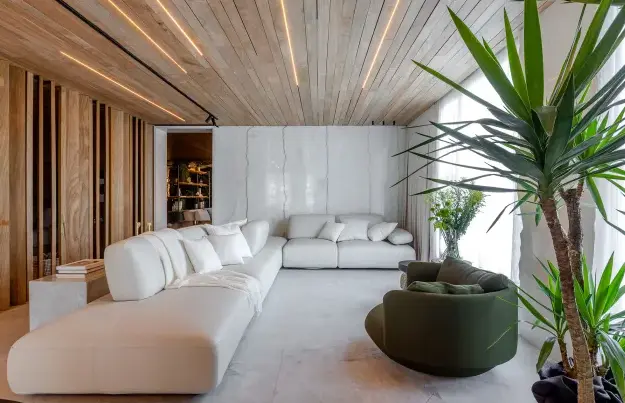 Almost monochromatic elegance and natural elements come together in this living room with a corner sofa – Project: Michael Zanghelini | Photo: Fabio Severo Jr/CASACOR