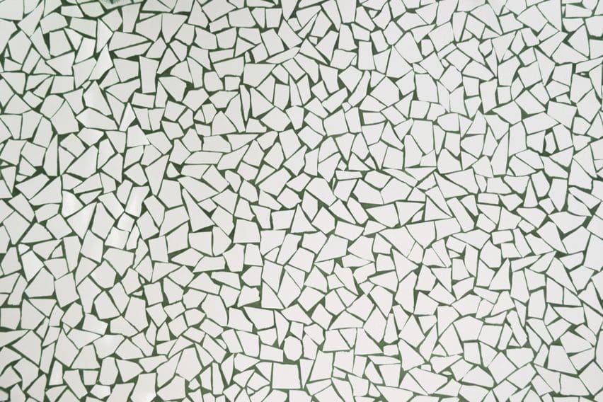 RA! clad the walls and floors in a distinctive mosaic of broken ceramic tiles with green joints as an ode to Barcelona