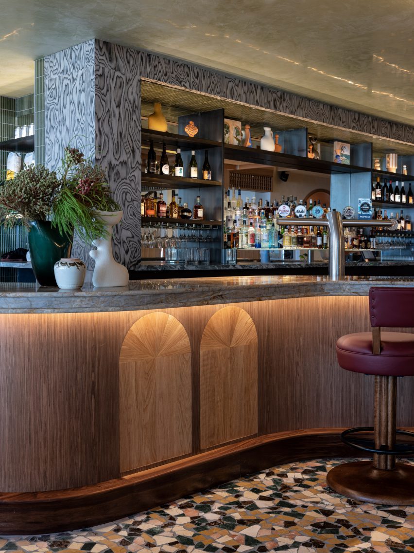 Crazy paving in autumnal hues defines the bar area
