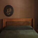 Chocolate brown bedroom with custom leather headboard