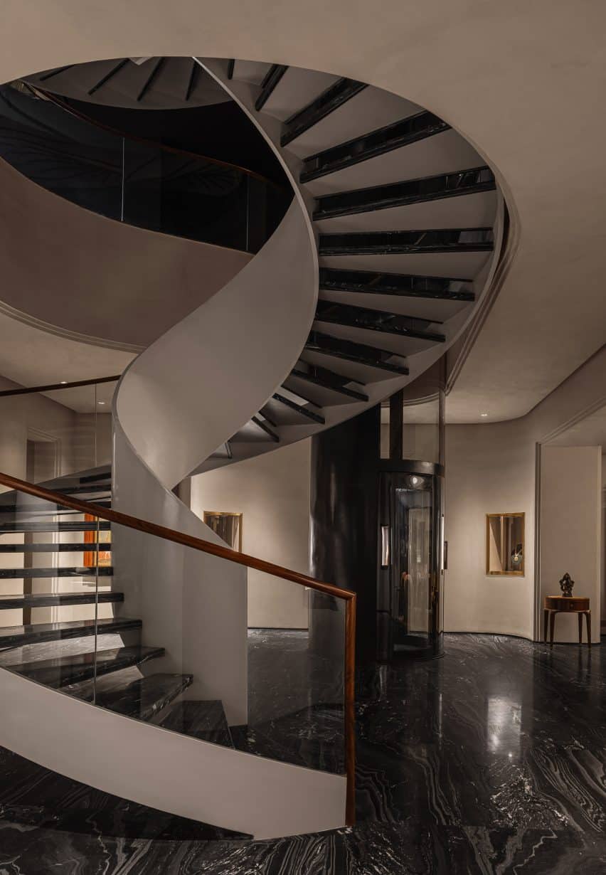 A view from inside the building showing a curved staircase that connects the various levels and enhances the flow of the space.