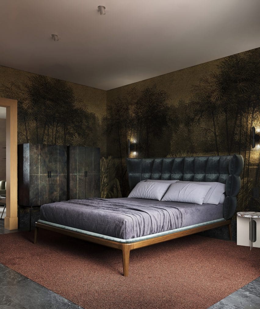 Dark botanical wallpaper frames the bedroom