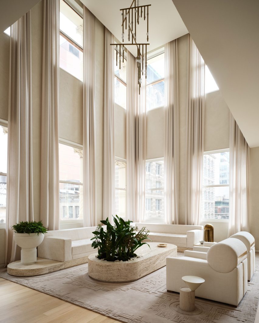 Timothy Godbold Transforms Tribeca Loft with Modernist Design Elements 2 A double-height living room surrounded by windows