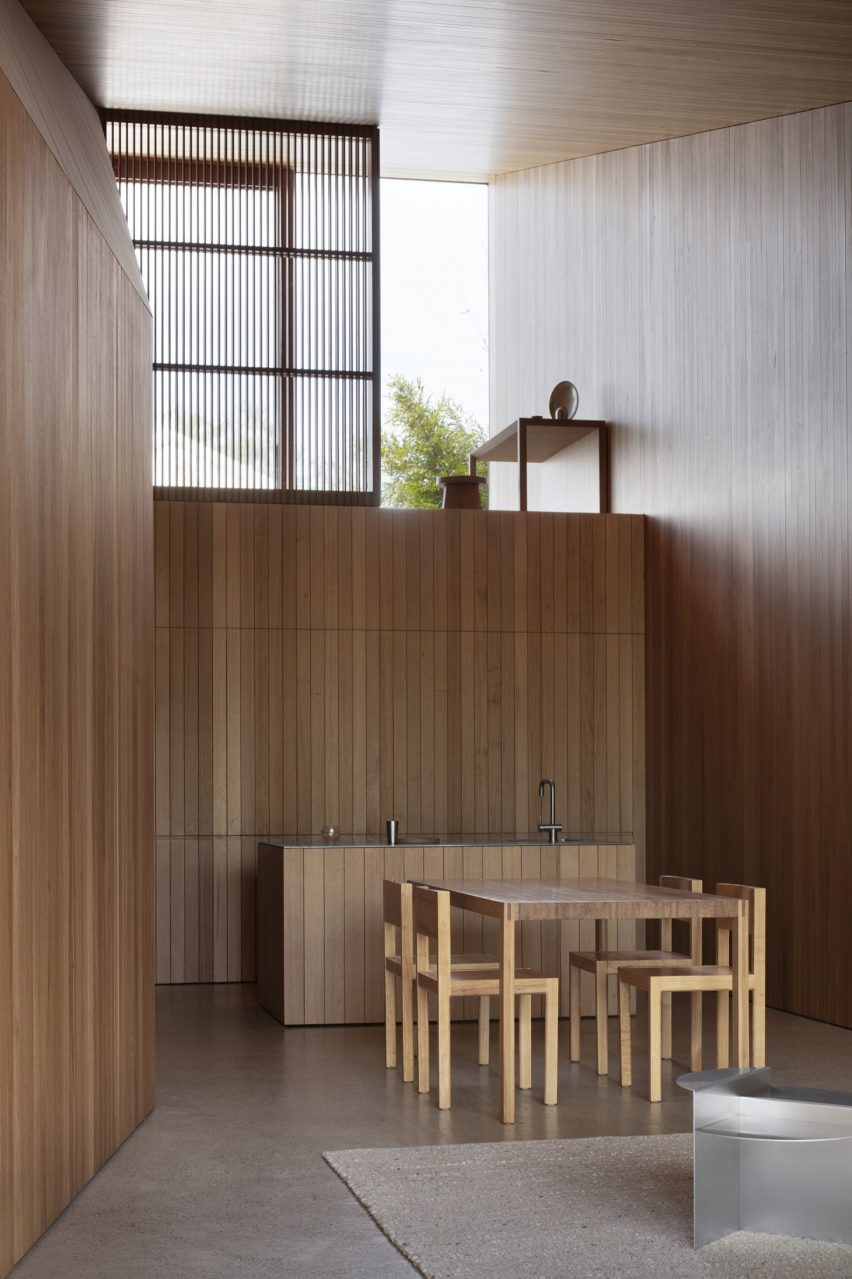 Inside, the wooden surfaces provide warmth amid the folded geometry of the architecture.