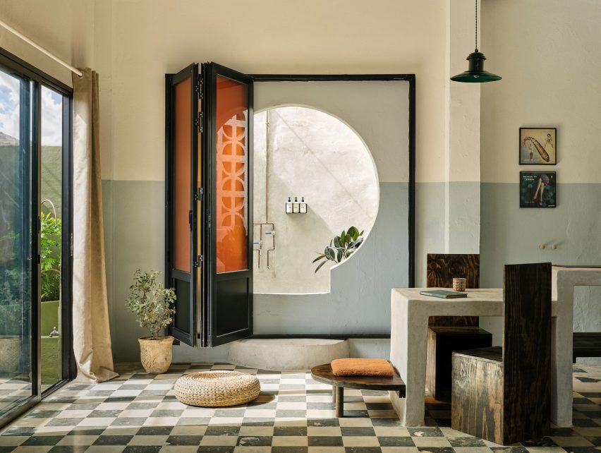 Verde 1 studio features concrete furniture and a giant keyhole that leads to an outdoor shower.