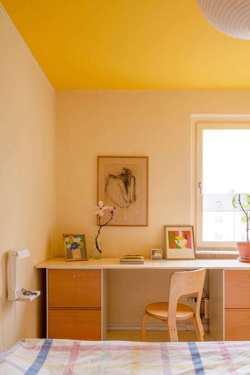In Stockholm, this apartment incorporates yellow in walls and ceilings, enriching the overall design.