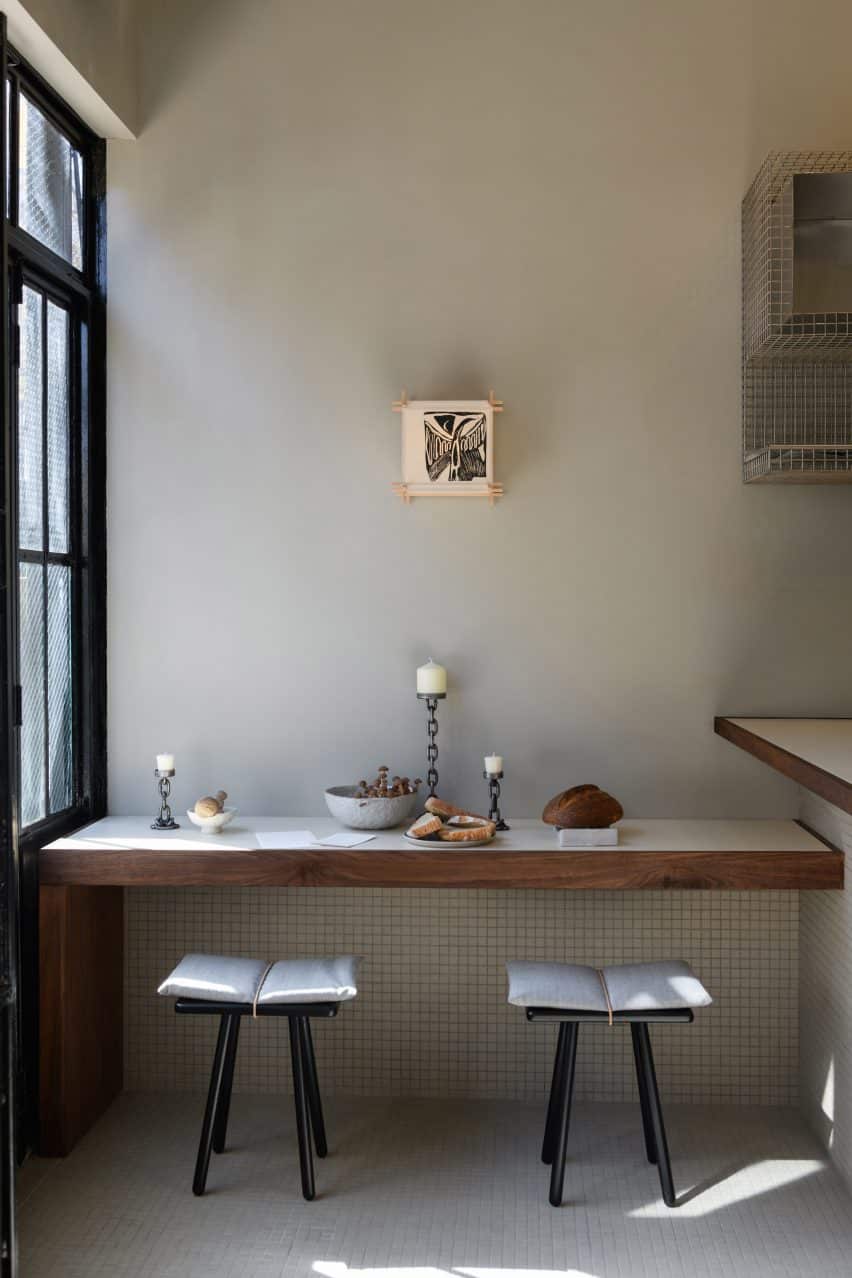 Serene interior with minimalist design and walnut banquettes creating a cozy setting.