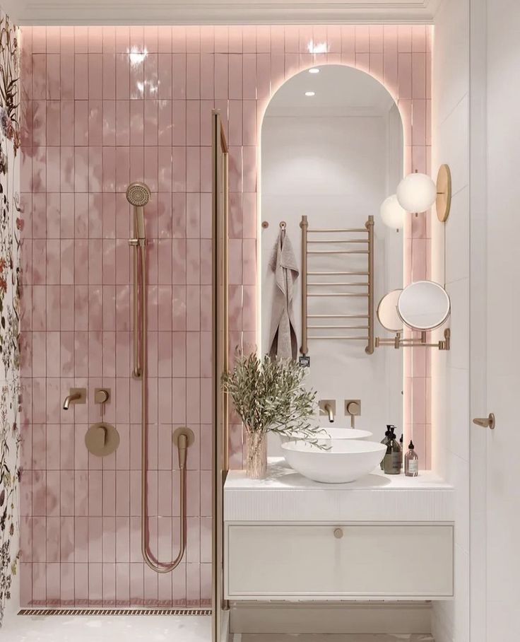Bathroom with pink tiles and white ceramics with rose gold details