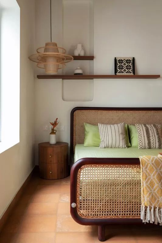 Double bedroom with slatted headboard and stylized wooden bedside table