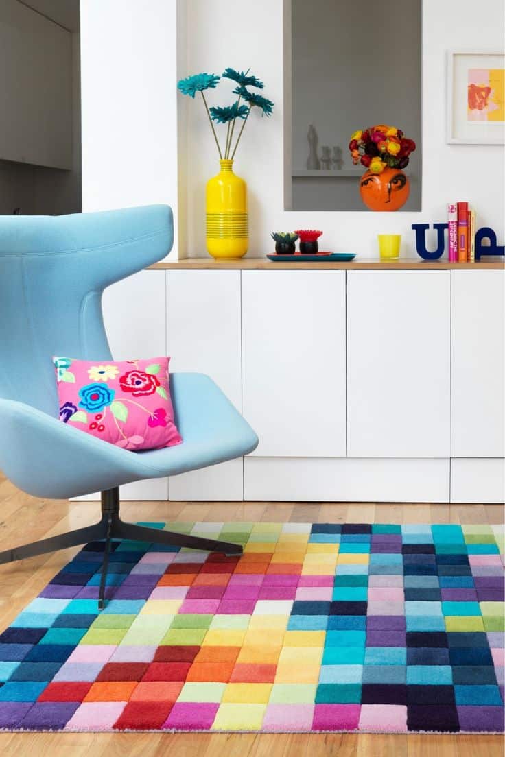 Vibrant Rugs That Transform Your Home Décor Effortlessly. 1 Blue chair and colorful rug