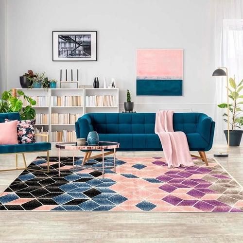 Vibrant Rugs That Transform Your Home Décor Effortlessly. 4 Bright room with blue sofa and geometric colored rug