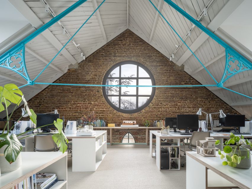 Tigg + Coll Architects Rehabilitate a Victorian Church into Modern Studios 3 First-floor workspace featuring a restored rose window that enhances the aesthetic appeal.