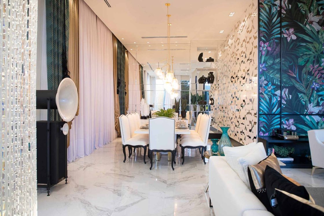 Sala de jantar e estar com paredes revestidas de diversas maneiras