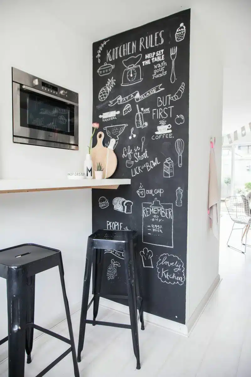 Visual de um ambiente com parede de lousa e decoração.