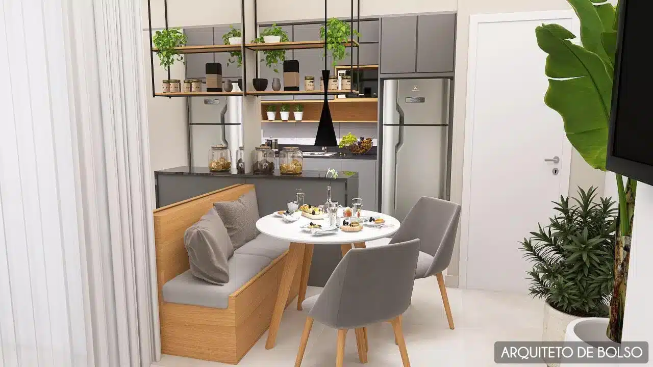 Imagem de uma cozinha americana com mesa de jantar integrada.